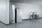 The picture shows the Vitocrossal 300 type CU3A gas condensing boiler with a Vitocell DHW cylinder in a basement, next to a mountain bike.